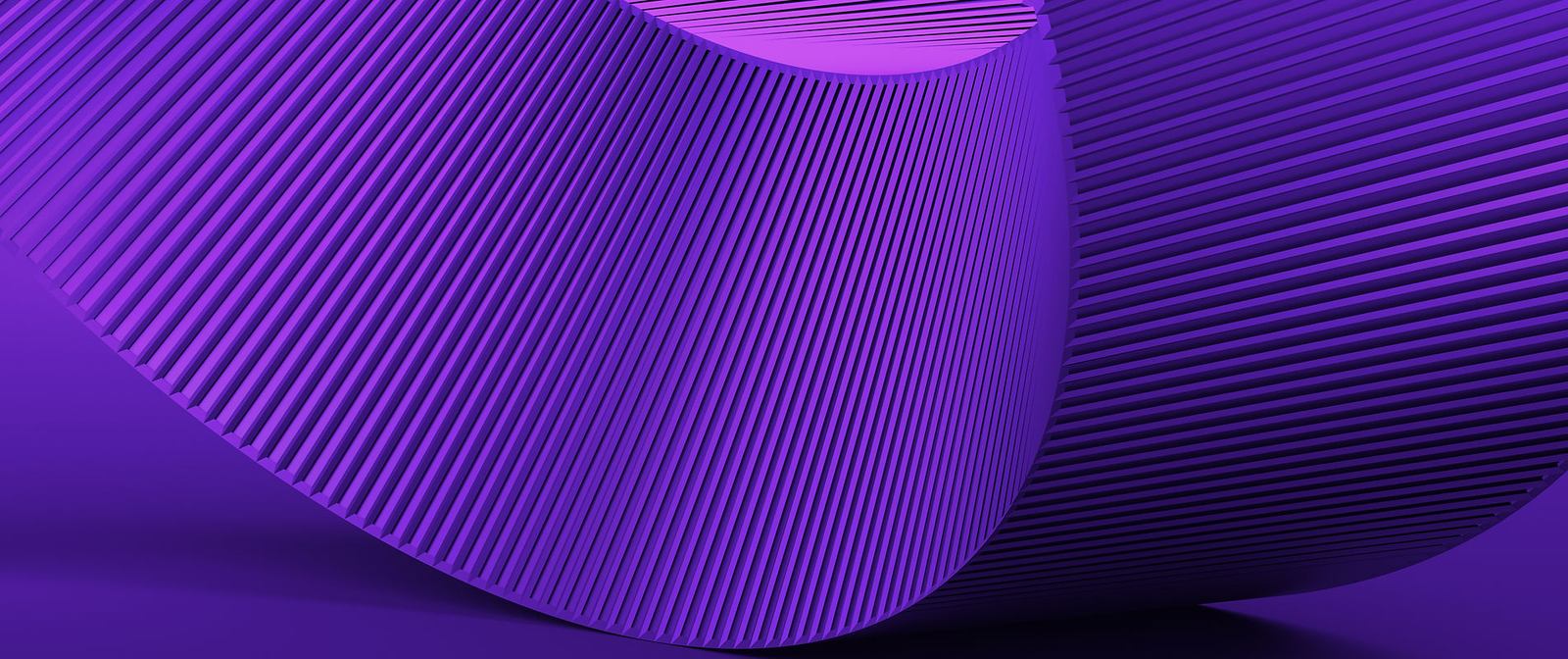 A ribbed violet surface curving away from the light, its fluting casting fine parallel shadows.